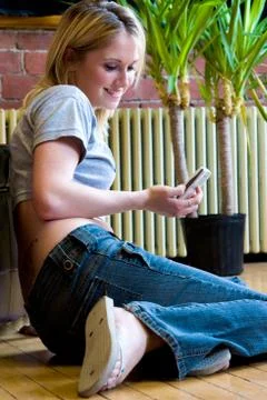 Checking messages on cellphone Stock Photos