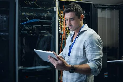 Checking the network status. Cropped shot of a handsome young male programmer 写真素材