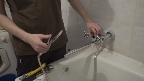 Checking the new faucet in the bathroom Stock Footage 108308565