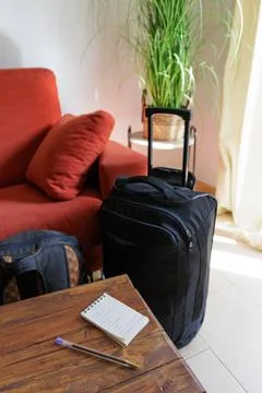 Checking in a notebook what we have put in the travel suitcase Stock Photos