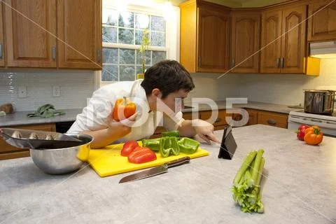 Checking online for cooking instructions Stock Photos