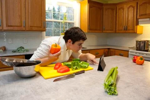 Checking online for cooking instructions Stock Photos