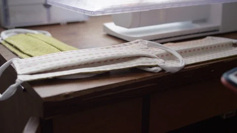 Checking online instructions on phone to make PPE face masks Video stock 128149566