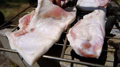 Checking or inspecting thin slice of salted pork belly fat while dry on open air 스톡 동영상 246713105