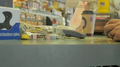 Checking out at gas station counter.  Video stock 81052877