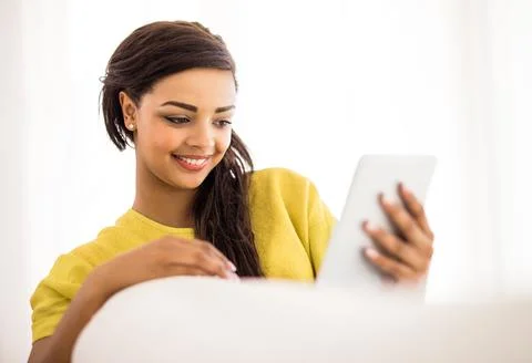 Checking out some funny pics online. Shot of a young woman using a digital ta Foto stock