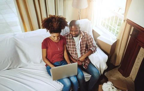 Checking out some interior designs for their living space. a young couple using Stock Photos
