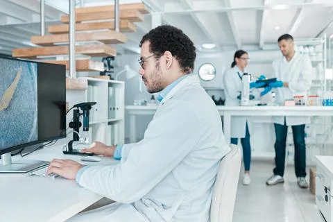 Checking over the facts multiple times. a young scientist using a digital Stock Photos