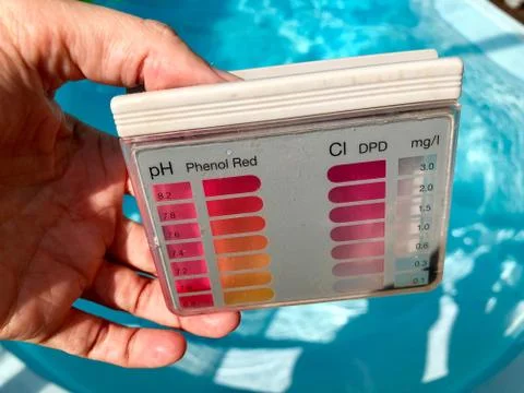 Checking pH level in blue outdoor pool Stock Photos