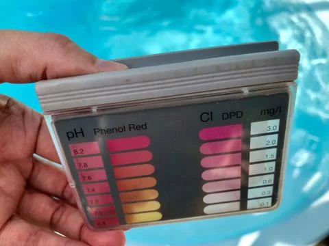 Checking pH level in blue outdoor pool Stock Photos