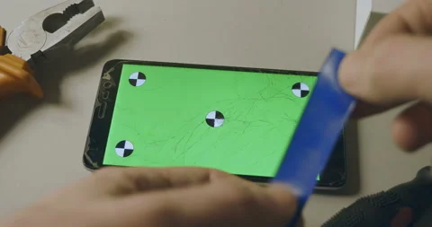 Checking phone with broken screen, fixing, smartphone with green screen Stock Footage 93334279