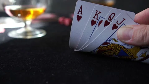 Checking playing cards with winning combination on the black table, poker game Stock Footage 133156354