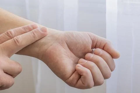 Checking Pulse On Wrist With Fingers Stock Photos
