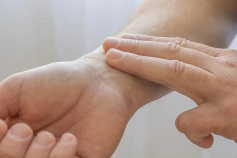 Checking Pulse On Wrist With Fingers Stock Photos