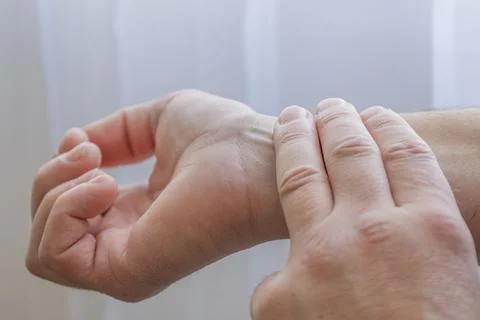 Checking Pulse On Wrist With Fingers Stockfoto's