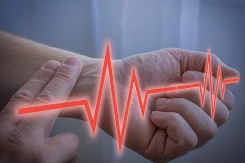 Checking Pulse On Wrist With Fingers Fotos de archivo