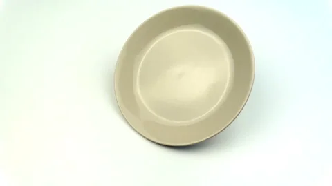 Checking the quality of dish for strength in slow motion. Unbreakable plate. Stock Footage 116396613