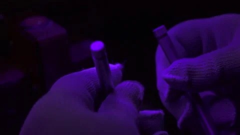 Checking the quality of the valve under UV rays Stock Footage 139699885