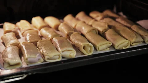 Checking the Readiness of Meat Crepe Rolls Inside a Hot Oven1 Stock Footage 332159779