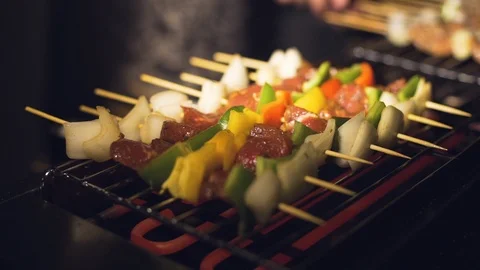 Checking the readiness of skewers during cooking. Stock Footage 116395686