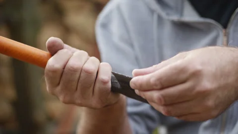 Checking the sharpness of a slightly worn axe blade by touching the edge wi.. Video stock 288998161