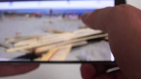 Checking smartphone cell phone Facebook news feed closeup finger sliding screen Stock Footage 77632977