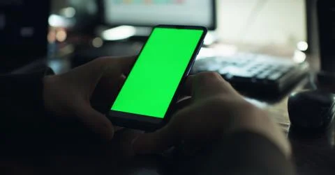 Checking the smartphone at the desk Stock Photos