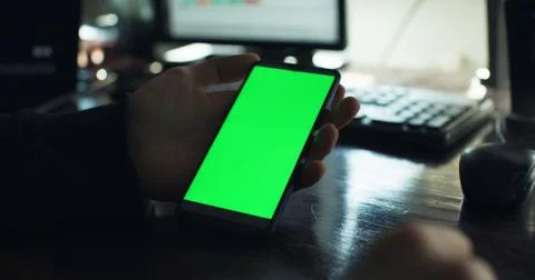 Checking the smartphone at the desk Photos