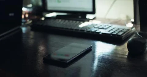 Checking the smartphone at the desk Stock Photos