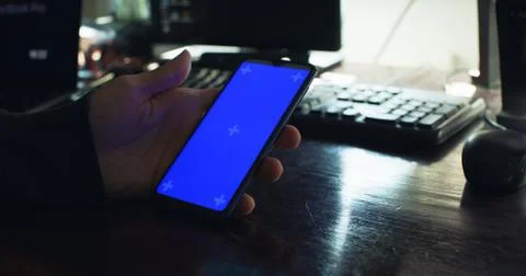 Checking the smartphone at the desk Stock Photos