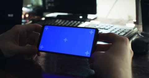 Checking the smartphone at the desk Stock Photos