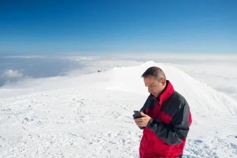 Checking smartphone on the top Stockfoto's