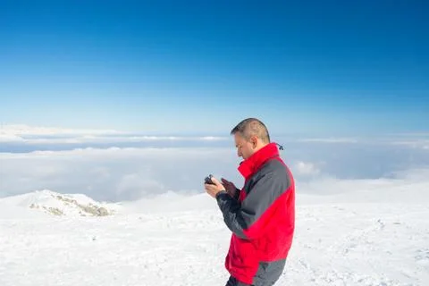 Checking smartphone on the top Foto stock