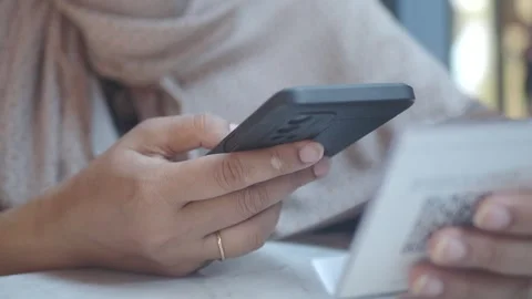 Checking a smartphone while scan QR code at cafe Stock Footage 317527475