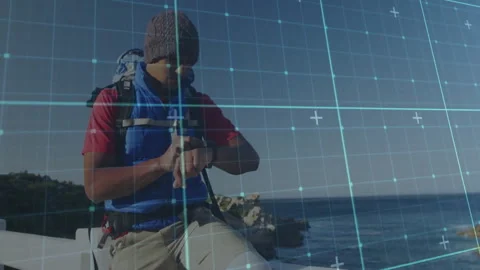Checking smartwatch, man standing near ocean with digital animation grid pattern Stock Footage 305118814