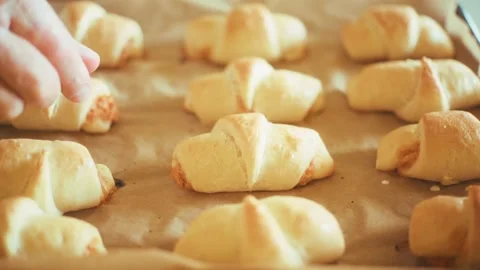 Checking softness of baked crescent rolls close up, fresh homemade savory Stock Footage 337877499