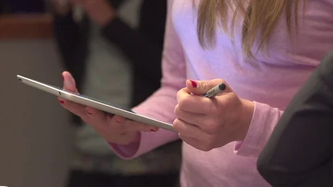 Checking someone in on iPad sign-in 2 Stock Footage 82812408