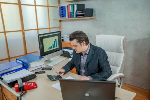 Checking something on a calculator Stock Photos