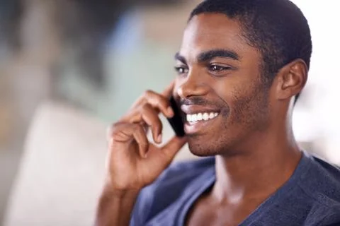 Checking up on that special someone. a handsome young man using his cellphone Stock Photos