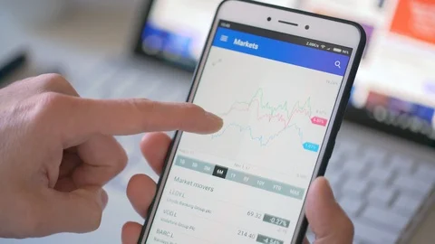 Checking stock market data on a smartphone Stock Footage 85822619