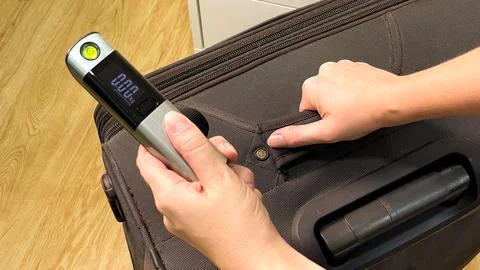 Checking suitcase weight before a trip Stock-Fotos