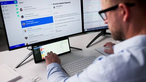 Checking Support Tickets On Secondary Screen Stock Footage 328709089