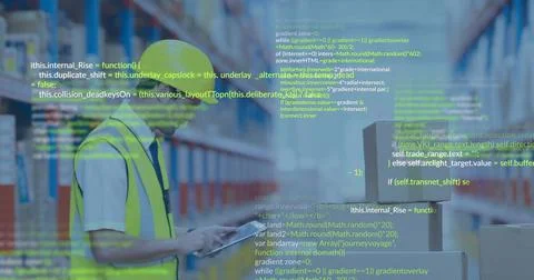 Checking tablet, worker wearing yellow hardhat, vest in aisle with boxes, green Foto stock