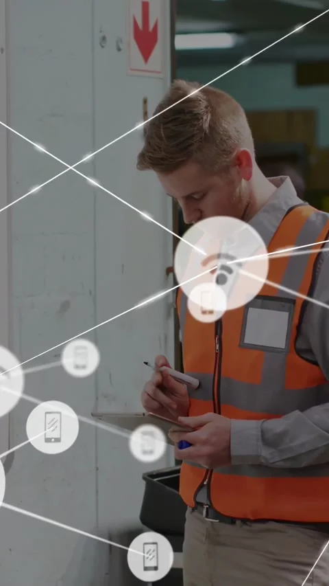 Checking tech in orange vest at warehouse white pillar red arrow, noting Stock Footage 331168892