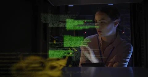 Checking tech in pink blouse, lanyard, inspecting racks in server room with Stock Photos
