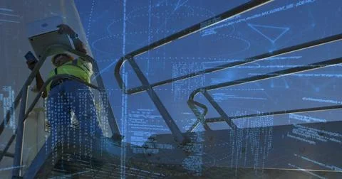 Checking tech using phone-tablet on raised deck, wearing hi-vis vest, with co Stock Photos