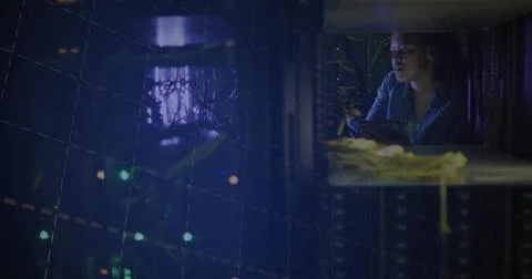 Checking tech wearing blazer inspecting rack at data center, holding tablet a Stock Photos