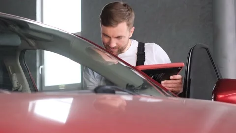 Checking the technical condition of the car using a tablet. Stock Footage 212344780