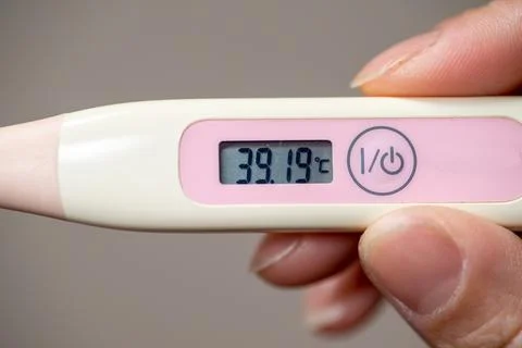 Checking temperature at home with digital thermometer Stock Photos