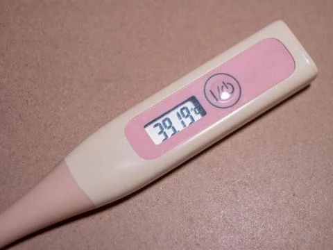 Checking temperature at home with digital thermometer Stock Photos